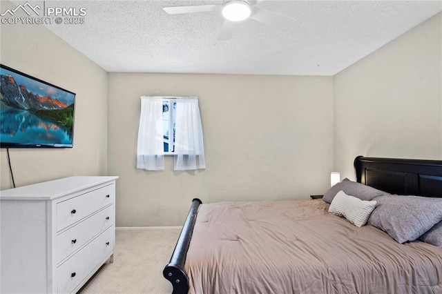 bedroom with baseboards, ceiling fan, light carpet, and a textured ceiling