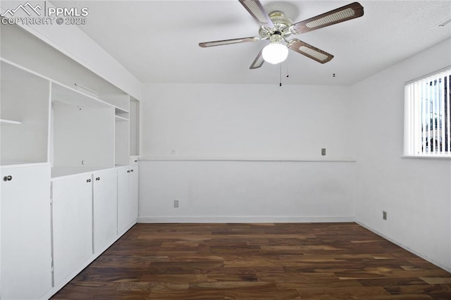 unfurnished bedroom featuring a ceiling fan, baseboards, and dark wood finished floors