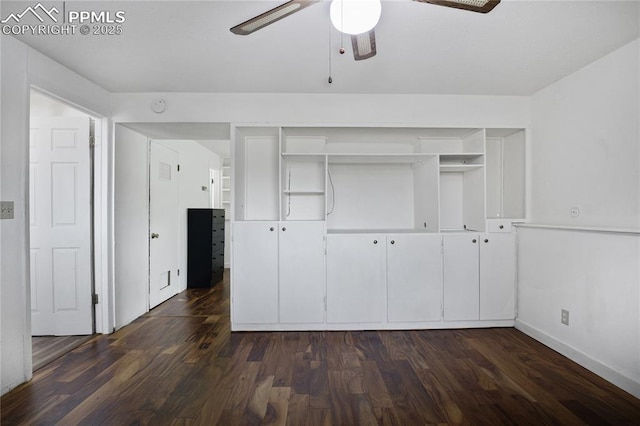 unfurnished bedroom featuring baseboards, dark wood-style flooring, ceiling fan, and a closet