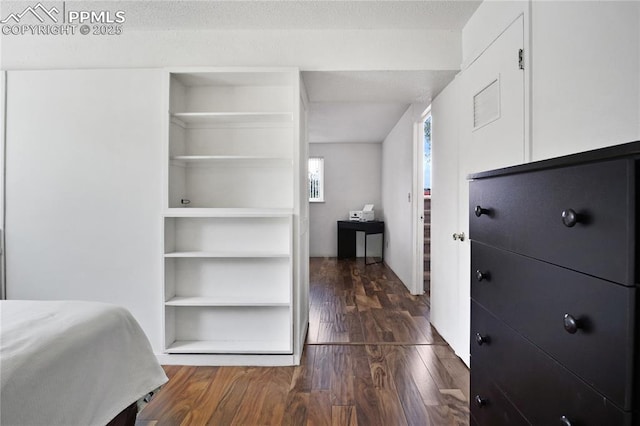 unfurnished bedroom with dark wood finished floors