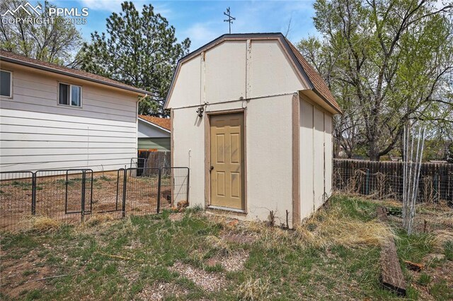 view of shed with a fenced backyard
