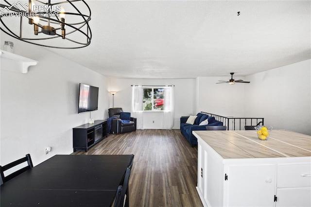 living room with a ceiling fan and dark wood-style flooring