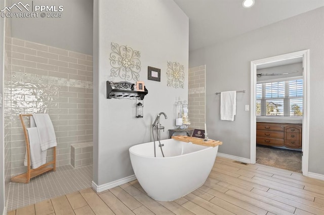 5409 Haes Haven Vw, Colorado Springs, CO 80908 - bathroom featuring a freestanding bath, visible vents, baseboards, and wood tiled floor