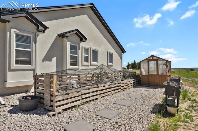 5409 Haes Haven Vw, Colorado Springs, CO 80908 - view of property exterior featuring stucco siding, an outbuilding, and an exterior structure