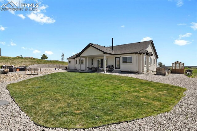 5409 Haes Haven Vw, Colorado Springs, CO 80908 - back of property featuring an outbuilding, stucco siding, a yard, and a patio area