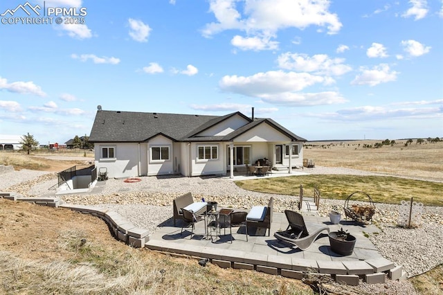 5409 Haes Haven Vw, Colorado Springs, CO 80908 - back of property featuring an outdoor fire pit, stucco siding, roof with shingles, and a patio area