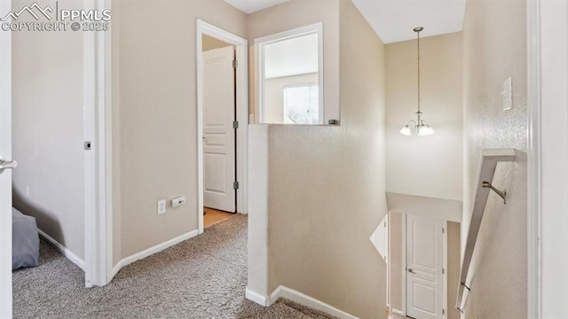 70 Audubon Dr, Colorado Springs, CO 80910 - hallway with baseboards, an upstairs landing, and carpet