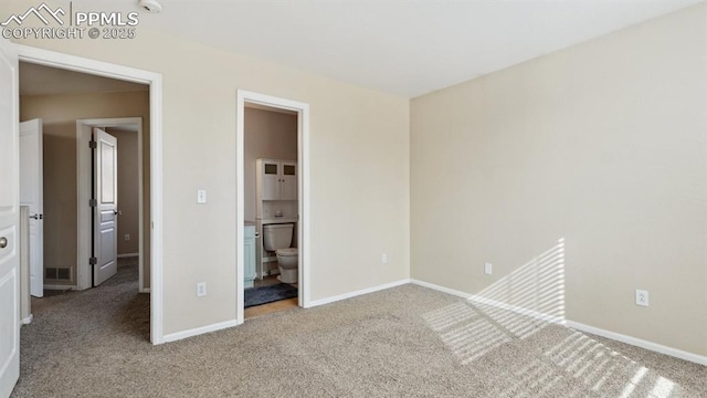 70 Audubon Dr, Colorado Springs, CO 80910 - unfurnished bedroom featuring baseboards, carpet floors, connected bathroom, and visible vents