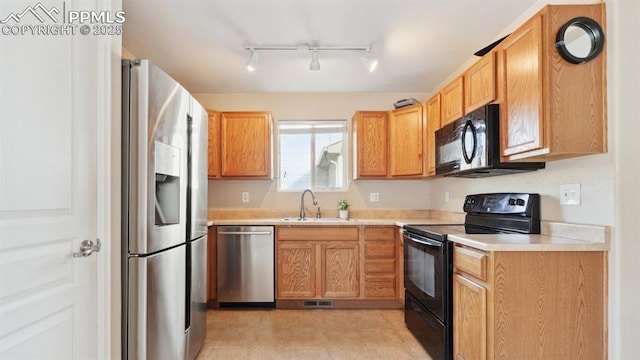 70 Audubon Dr, Colorado Springs, CO 80910 - kitchen with light countertops, a sink, black appliances, and visible vents