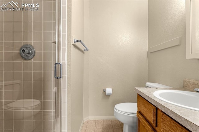 bathroom with baseboards, toilet, a stall shower, tile patterned floors, and vanity