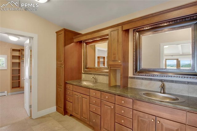 full bathroom with double vanity, a sink, and plenty of natural light