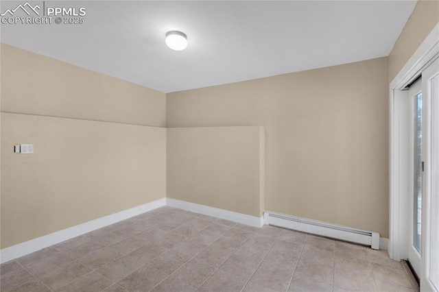 spare room featuring baseboard heating, baseboards, and light tile patterned floors