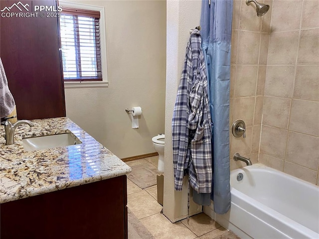 bathroom with shower / bathtub combination with curtain, vanity, toilet, baseboards, and tile patterned floors