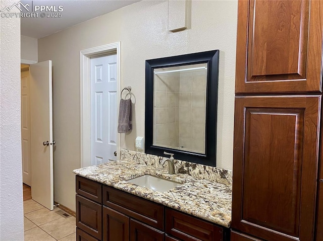 bathroom with visible vents, tile patterned flooring, and vanity