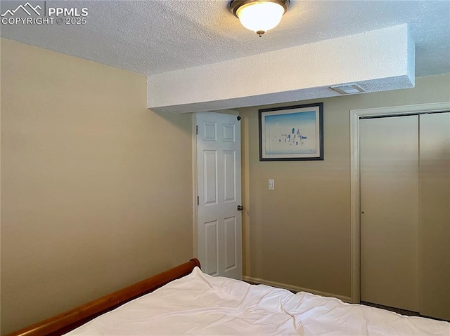 unfurnished bedroom featuring a closet and a textured ceiling
