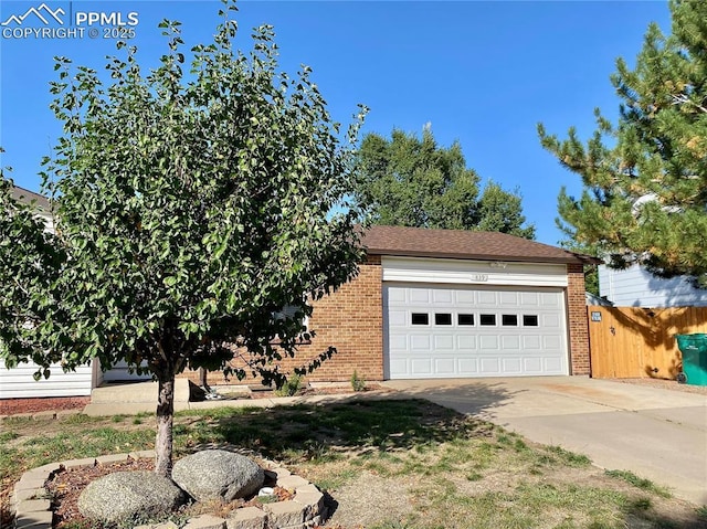 exterior space with brick siding, driveway, and a garage