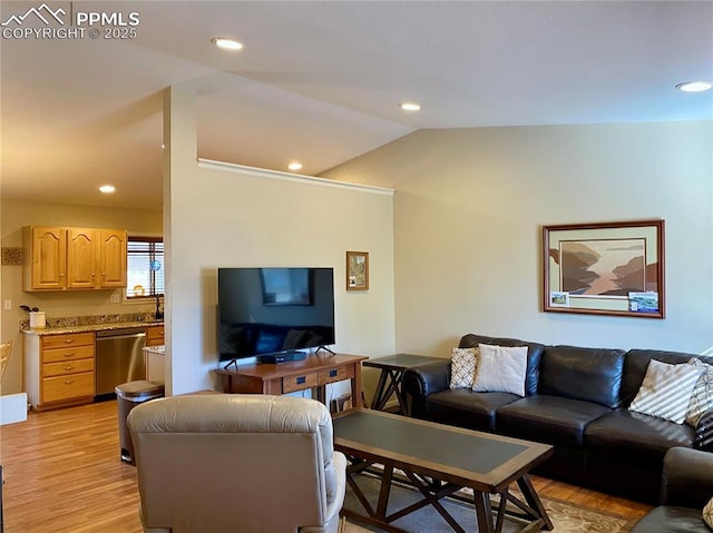 living room featuring lofted ceiling, light wood finished floors, and recessed lighting