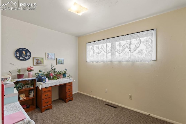 home office featuring visible vents, baseboards, and light colored carpet