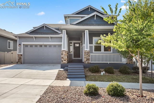 1632 Derbyshire St, Colorado Springs, CO 80910 - craftsman-style home featuring covered porch, stone siding, concrete driveway, an attached garage, and a shingled roof