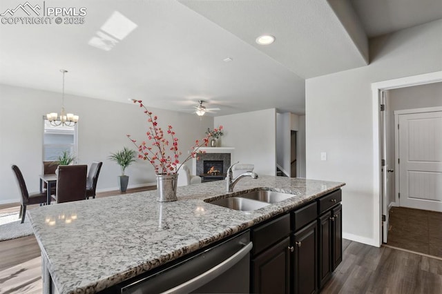 1632 Derbyshire St, Colorado Springs, CO 80910 - kitchen featuring dark wood-style flooring, a kitchen island with sink, a sink, ceiling fan with notable chandelier, and stainless steel dishwasher