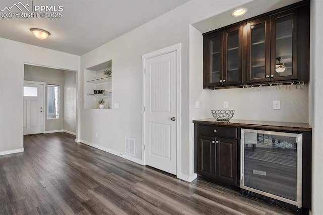 1632 Derbyshire St, Colorado Springs, CO 80910 - bar with dark wood-type flooring, baseboards, visible vents, and beverage cooler