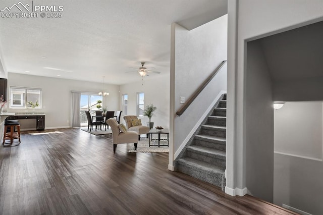 1632 Derbyshire St, Colorado Springs, CO 80910 - interior space with ceiling fan with notable chandelier, dark wood-style floors, stairway, and baseboards