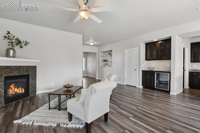 1632 Derbyshire St, Colorado Springs, CO 80910 - living area featuring dark wood-style flooring, visible vents, a ceiling fan, bar, and built in features