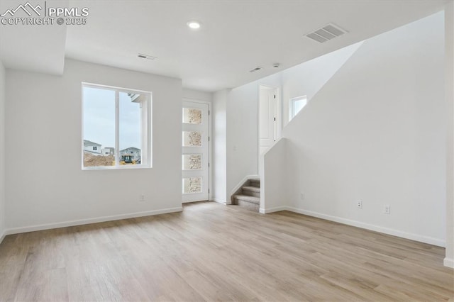 2489 Vanhoutte Vw, Colorado Springs, CO 80915 - unfurnished living room with wood finished floors, visible vents, and stairs