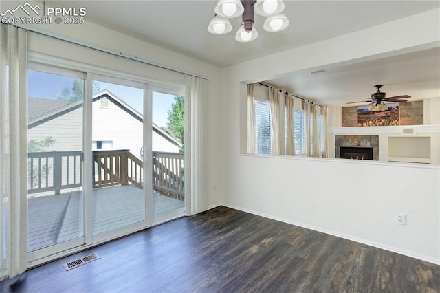4730 Jenson Ln, Colorado Springs, CO 80922 - unfurnished living room featuring a chandelier, wood finished floors, baseboards, a lit fireplace, and a ceiling fan