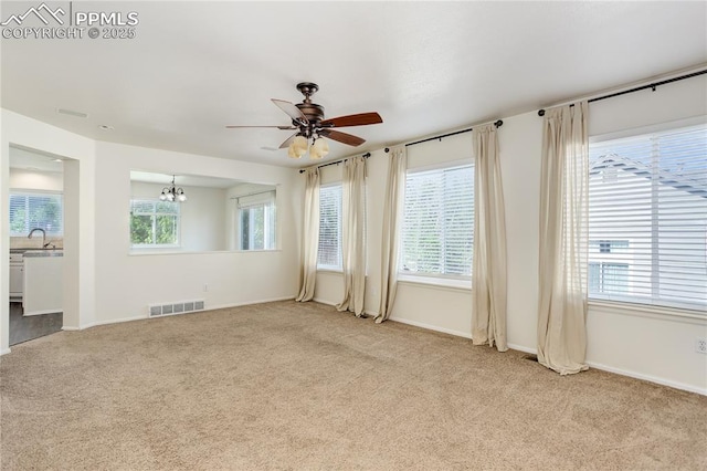 4730 Jenson Ln, Colorado Springs, CO 80922 - unfurnished room with light colored carpet, a ceiling fan, a chandelier, and baseboards