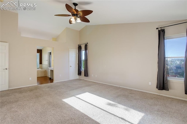 4730 Jenson Ln, Colorado Springs, CO 80922 - unfurnished bedroom with carpet floors, multiple windows, vaulted ceiling, baseboards, and ensuite bathroom