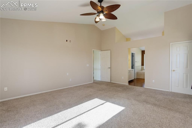 4730 Jenson Ln, Colorado Springs, CO 80922 - unfurnished bedroom featuring dark colored carpet, baseboards, ensuite bathroom, and high vaulted ceiling