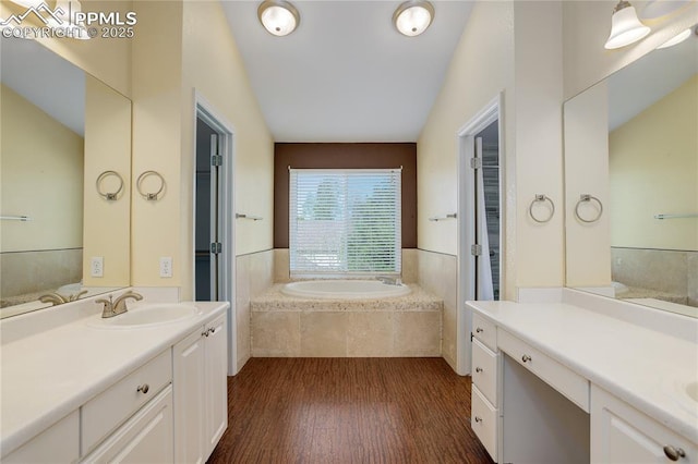 4730 Jenson Ln, Colorado Springs, CO 80922 - bathroom featuring wood finished floors, a garden tub, and two vanities