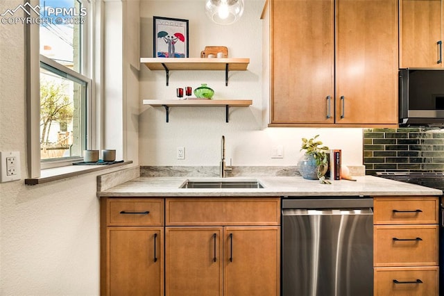 kitchen with brown cabinets, light stone counters, a sink, electric range oven, and stainless steel dishwasher