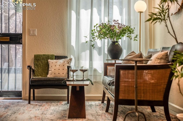 sitting room with a textured wall and a wealth of natural light