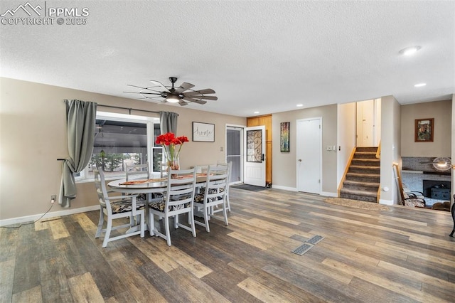 6770 Gun Club Trl, Colorado Springs, CO 80908 - dining room with visible vents, wood finished floors, stairway, baseboards, and ceiling fan