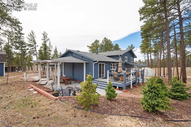 6770 Gun Club Trl, Colorado Springs, CO 80908 - back of house with an outbuilding, a deck, and roof with shingles