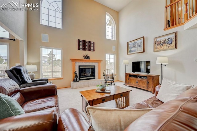 carpeted living room featuring baseboards, a fireplace, and visible vents
