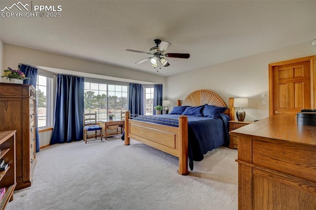 bedroom featuring ceiling fan and light carpet