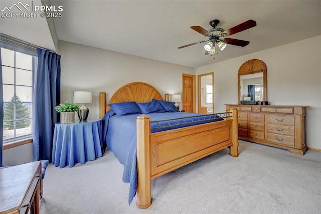 bedroom with a ceiling fan and light colored carpet