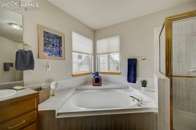 full bathroom with tiled shower, a garden tub, and vanity