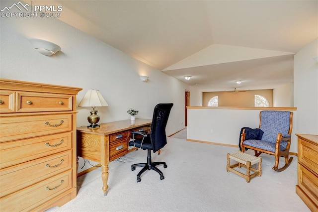 home office with light colored carpet, vaulted ceiling, ceiling fan, and baseboards