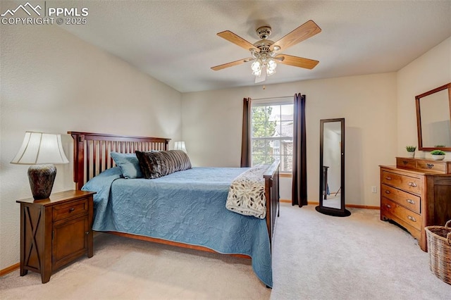 bedroom featuring light carpet, baseboards, and a ceiling fan