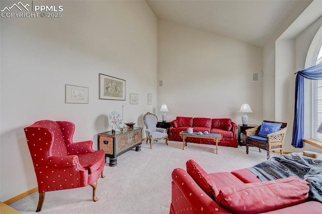 living room featuring high vaulted ceiling, carpet, and visible vents