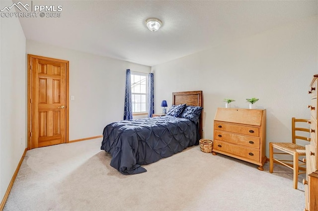 bedroom featuring baseboards and carpet floors