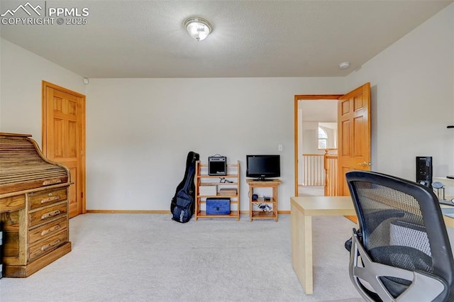 office with baseboards, light colored carpet, and a textured ceiling