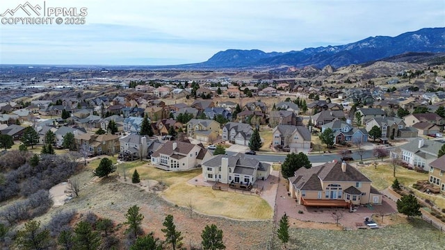 birds eye view of property featuring a mountain view and a residential view