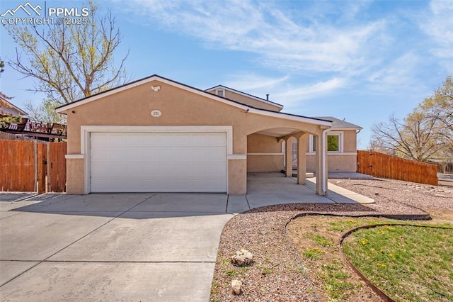 3781 Red Cedar Dr, Colorado Springs, CO 80906 - single story home featuring fence, an attached garage, stucco siding, and concrete driveway