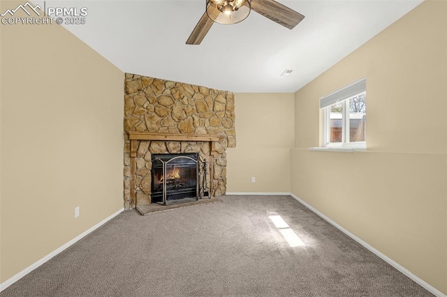 3781 Red Cedar Dr, Colorado Springs, CO 80906 - unfurnished living room featuring ceiling fan, a stone fireplace, vaulted ceiling, baseboards, and carpet flooring