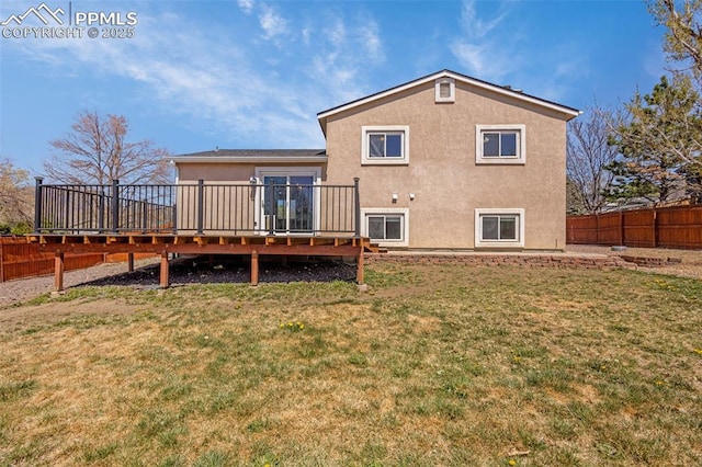 3781 Red Cedar Dr, Colorado Springs, CO 80906 - back of property with a fenced backyard, stucco siding, a yard, and a deck